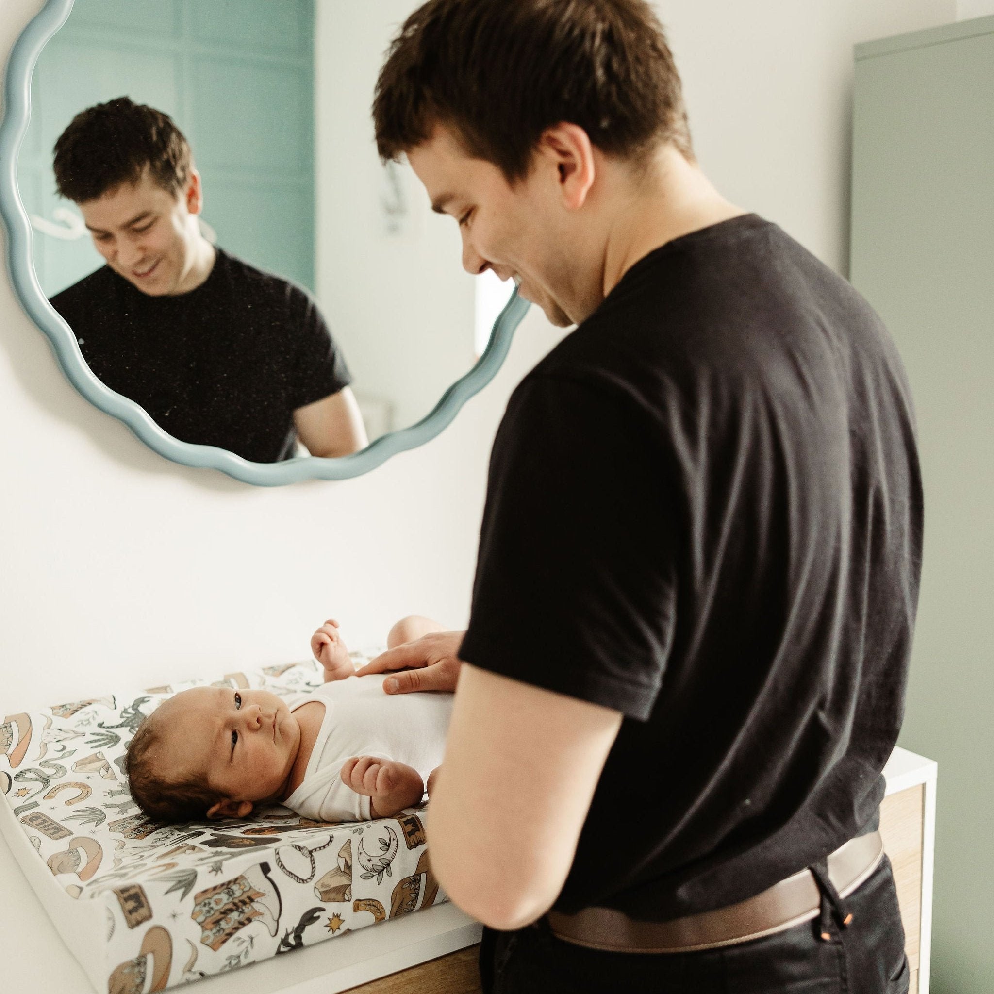 DAD CHANGING BABY ON WEDGE CHANGING MAT